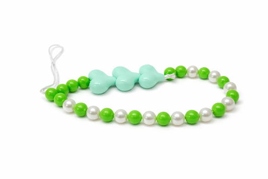 Necklace with green and white beads on a white background