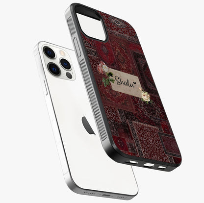 Velvet Wine Pattern Custom Name Glass Case laid diagonally highlighting side profile, edges and glossy glass shine.