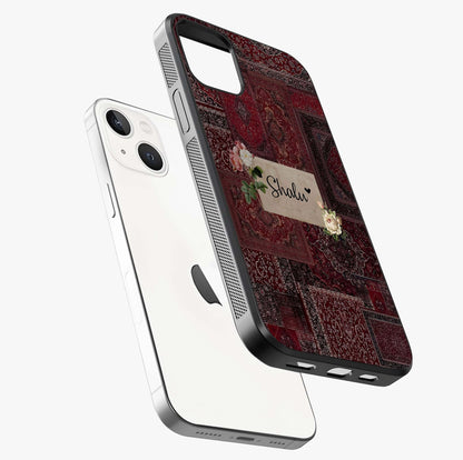 Velvet Wine Pattern Custom Name Glass Case laid diagonally highlighting side profile, edges and glossy glass shine.