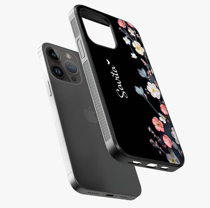 Black Elegance Floral Custom Name Glass Case laid diagonally highlighting side profile, edges and glossy glass shine.