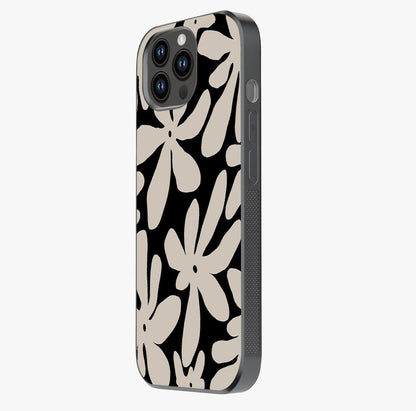 Monochrome Petal Dance Glass Case photographed in natural light showing reflective finish and design depth.