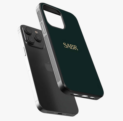 Sabr Minimal Patience Glass Case photographed in natural light showing reflective finish and design depth.
