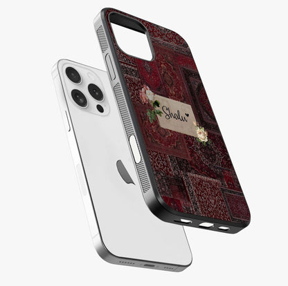 Velvet Wine Pattern Custom Name Glass Case laid diagonally highlighting side profile, edges and glossy glass shine.