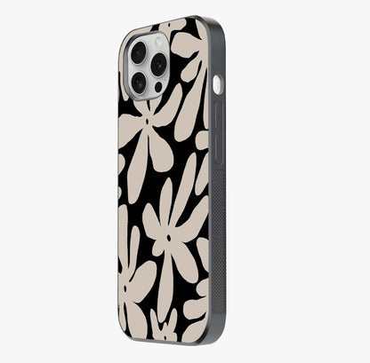 Monochrome Petal Dance Glass Case photographed in natural light showing reflective finish and design depth.