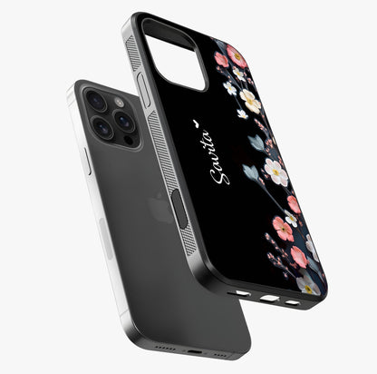 Black Elegance Floral Custom Name Glass Case laid diagonally highlighting side profile, edges and glossy glass shine.