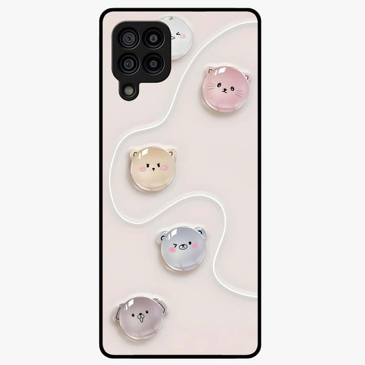 Puffy Face Parade Glass Case showing flat back view with cute puffy character faces artwork and glossy glass finish.