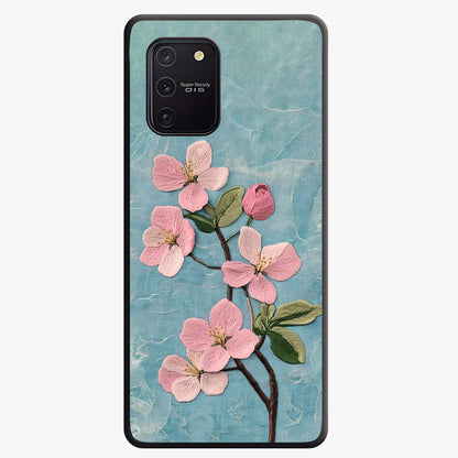 Threaded Blossom Breeze Glass Case showing flat back view with delicate blossom artwork and glossy glass finish.