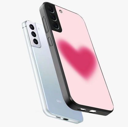 Pink Aura Heart Glass Case displayed in angled mockup highlighting vibrant pink heart design with dreamy aura aesthetic.