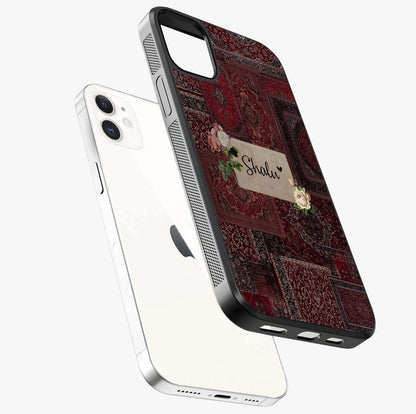 Velvet Wine Pattern Custom Name Glass Case laid diagonally highlighting side profile, edges and glossy glass shine.