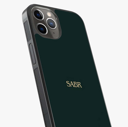 Sabr Minimal Patience Glass Case captured at a warm angle highlighting gloss, texture and premium glass finish.