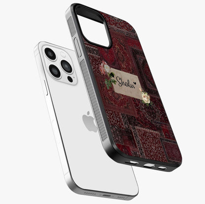 Velvet Wine Pattern Custom Name Glass Case laid diagonally highlighting side profile, edges and glossy glass shine.